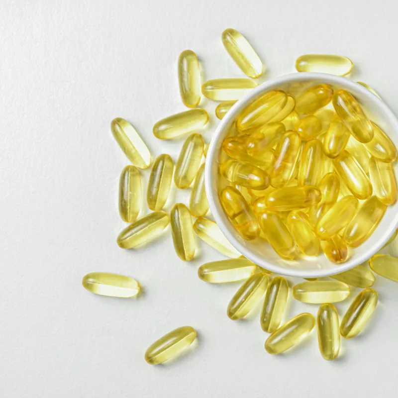 Omega-3 fish oil softgel capsules on white background